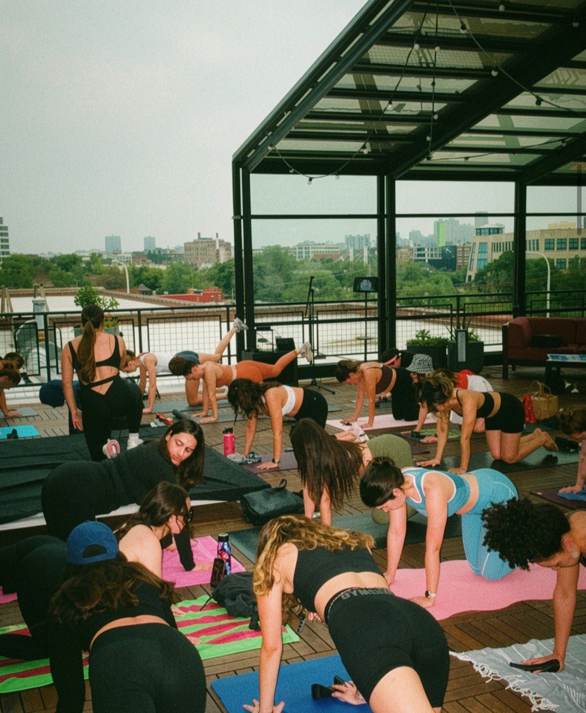 rooftop pilates on yoga mats with the Chicago skyline behind, HGVC x Adapty