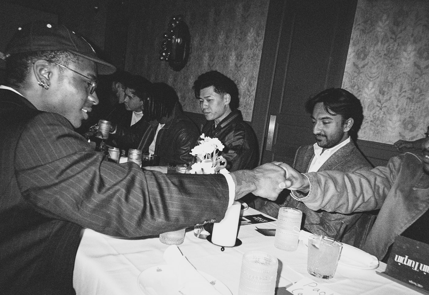 two guests shaking hands across the table