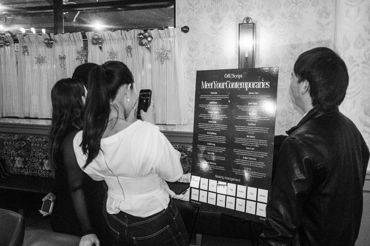guests reading the meet-your-contemporaries seating board