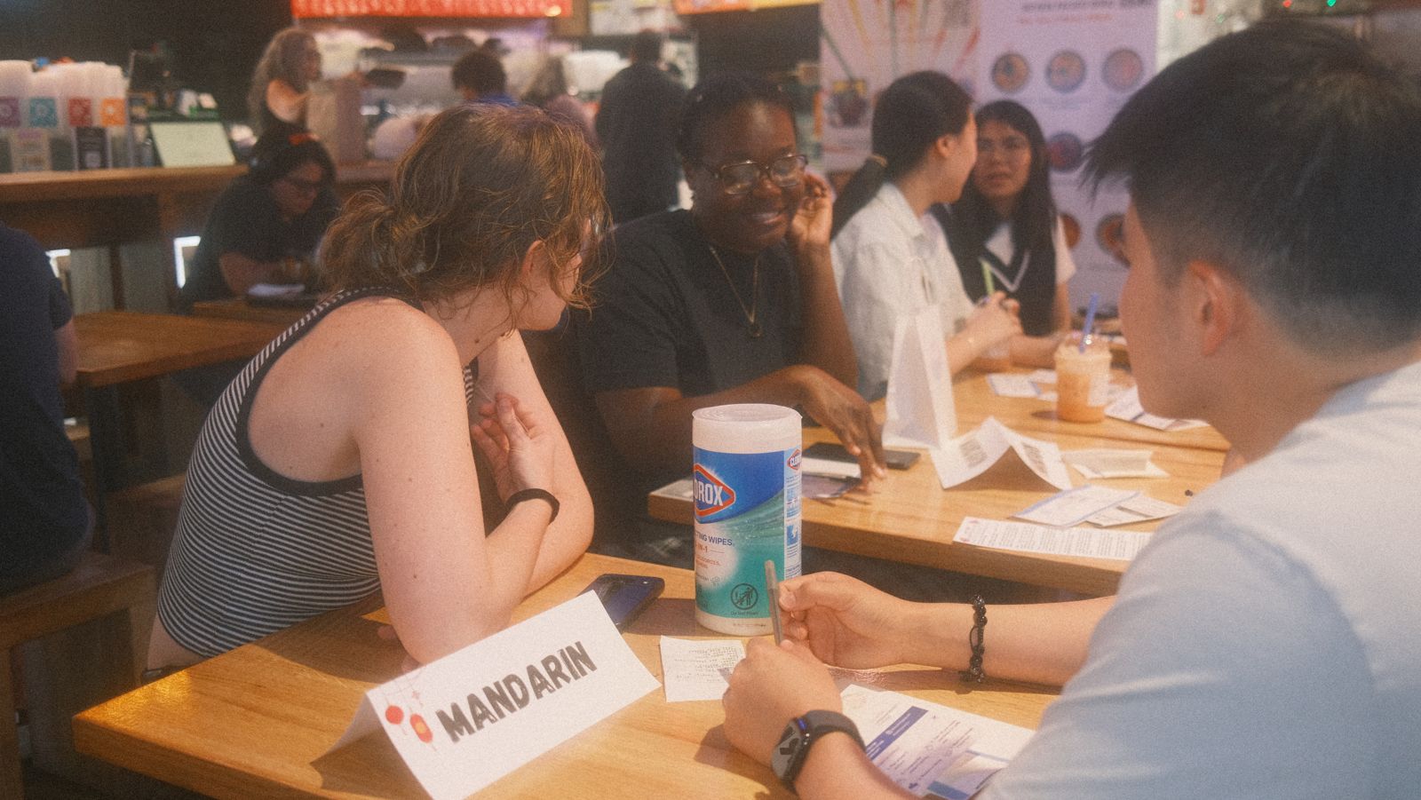 the mandarin table mid-laugh, table sign up front