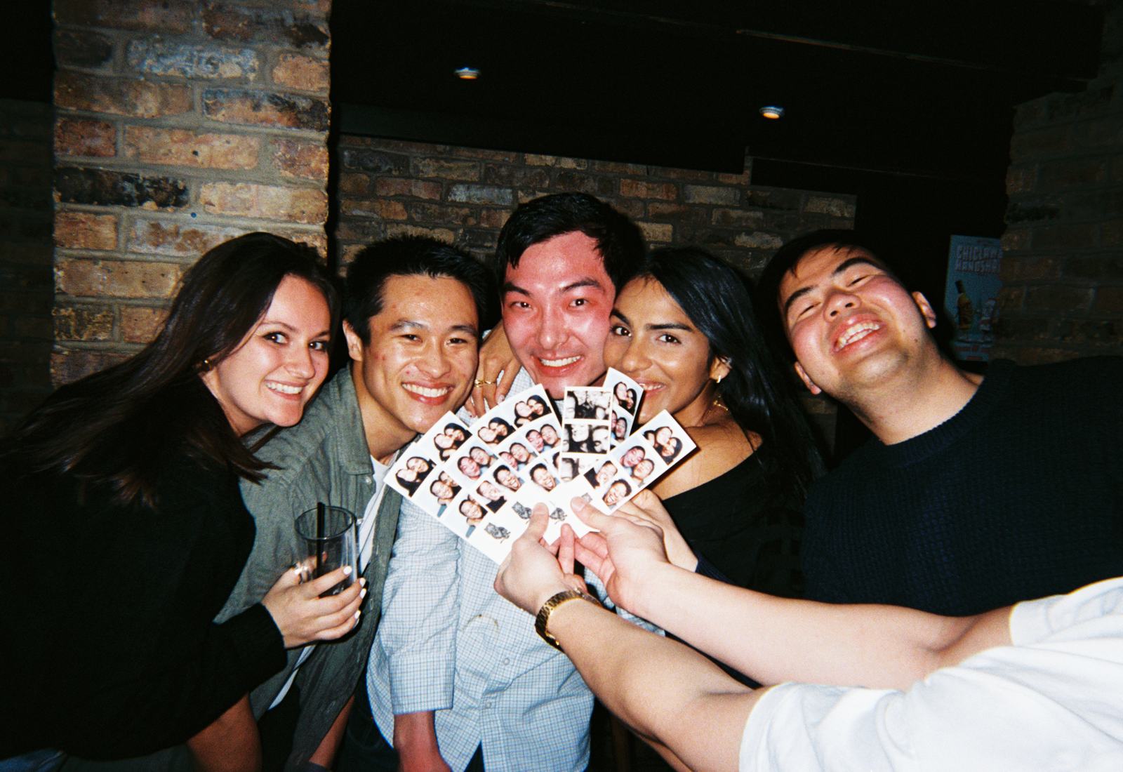 photobooth strips fanned out like a winning hand